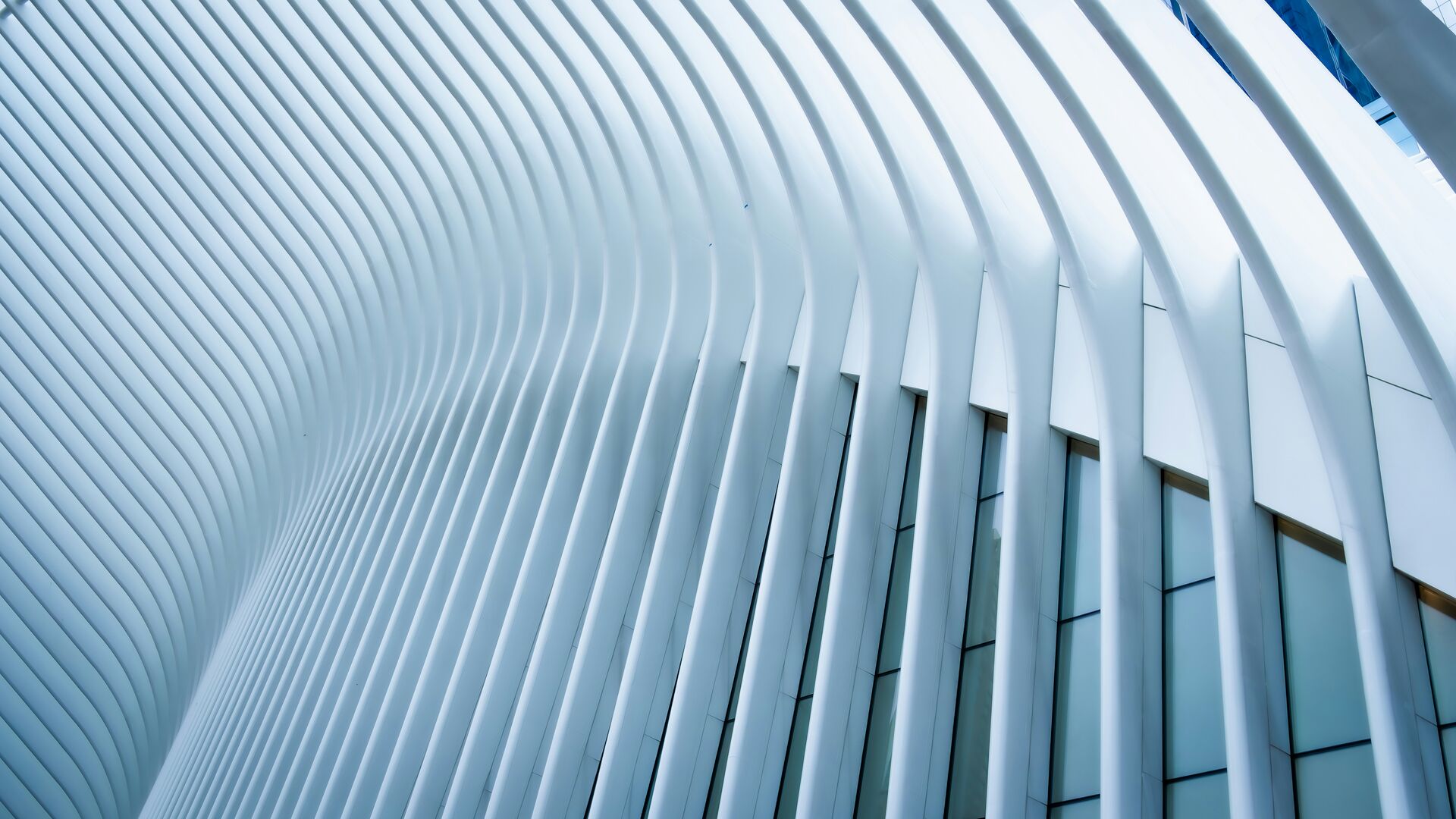 Curved white architectural fins of a modern building facade